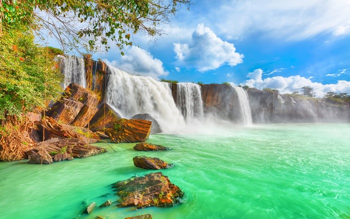 Majestic Waterfall Cascading Into Turquoise Pool