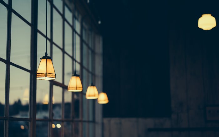 Hanging lamps in front of a large window