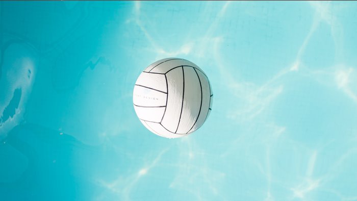 Water volleyball floating in pool water