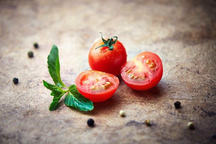 Tomatoes and mint on a textured surface