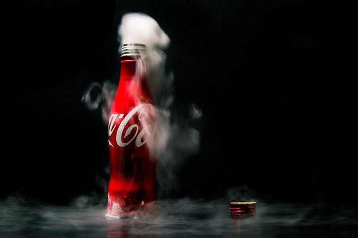 Coca-Cola bottle with smoke and cap