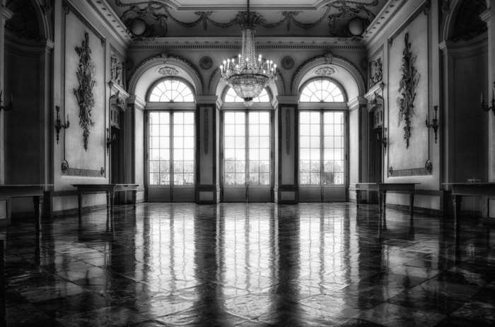 Grand hall with arched windows and chandelier