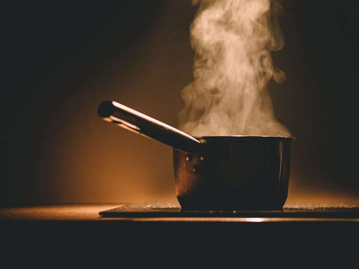Pot of steaming water on a stovetop