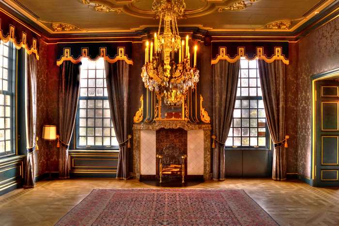Luxurious historic room with chandelier and fireplace