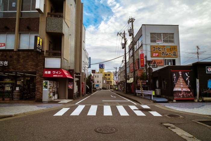 Street view in Japan with buildings and pedestrian crossing