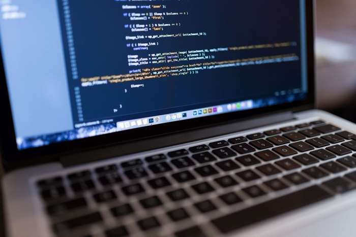 MacBook Pro displaying PHP code for WordPress