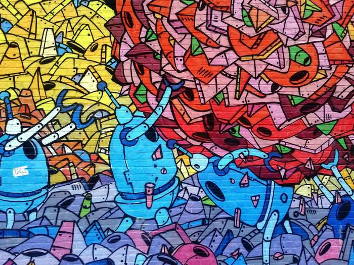 Graffiti mural with robots and abstract shapes