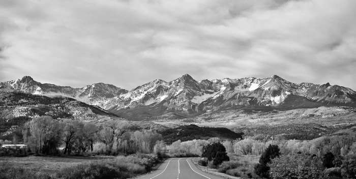 Black and white mountain landscape with a road