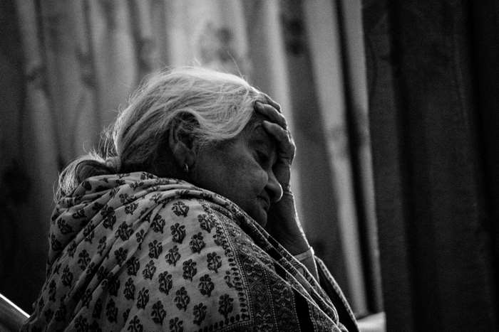 Black and white portrait of an elderly woman in distress