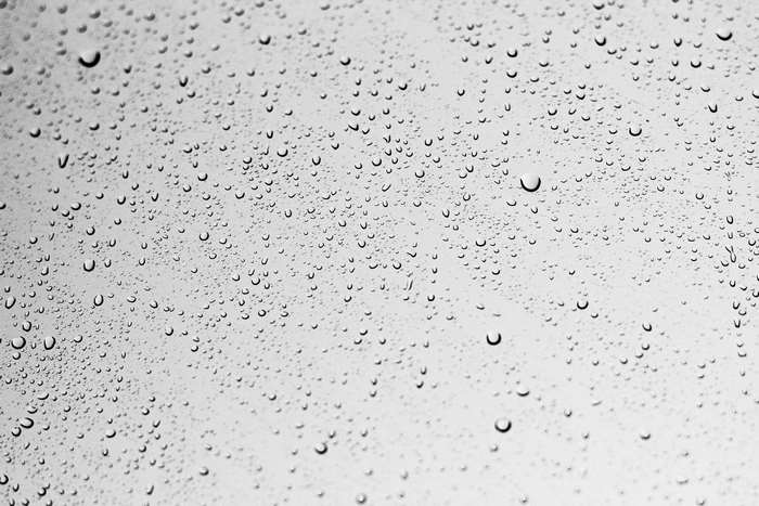 Water droplets on a gray surface