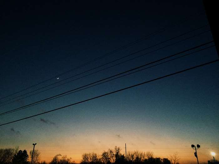 Crescent moon in the sky at sunset