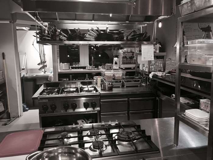 Industrial restaurant kitchen with stoves and equipment