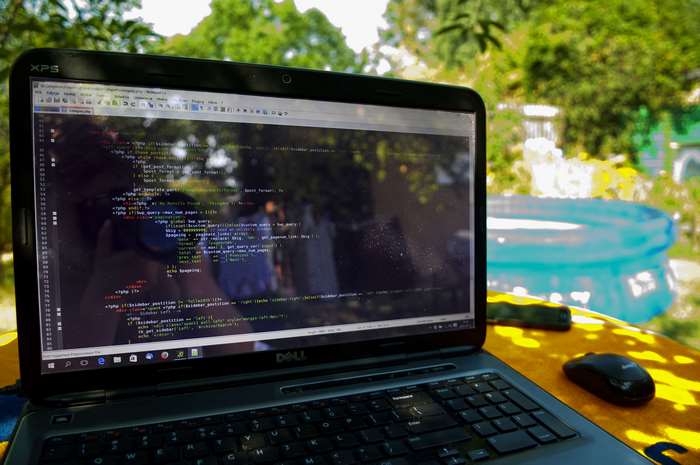 Dell laptop displaying code outdoors