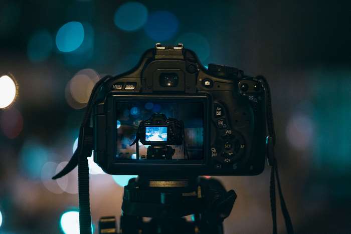 DSLR camera on tripod with bokeh background