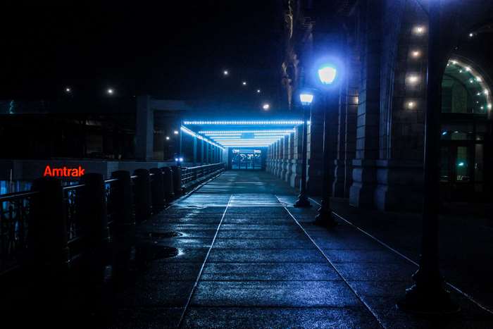 Night pathway at Amtrak station with blue lights