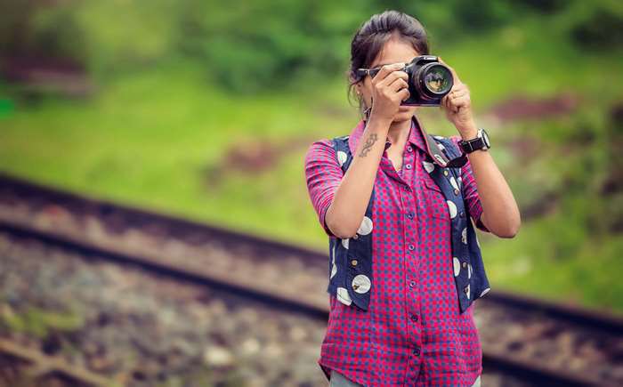 Woman taking a photo with a Canon DSLR camera