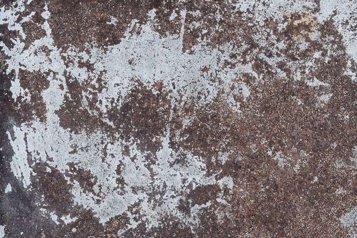 Rough concrete texture with white paint peeling