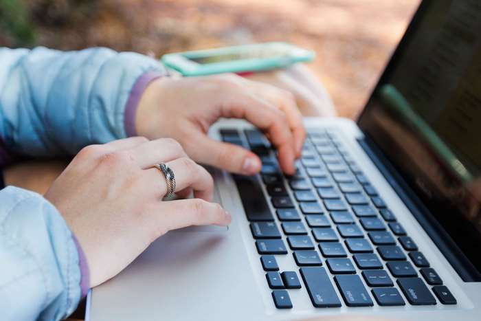 Woman typing on a laptop computer