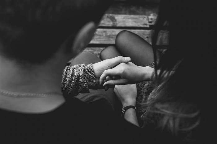 Couple holding hands, black and white