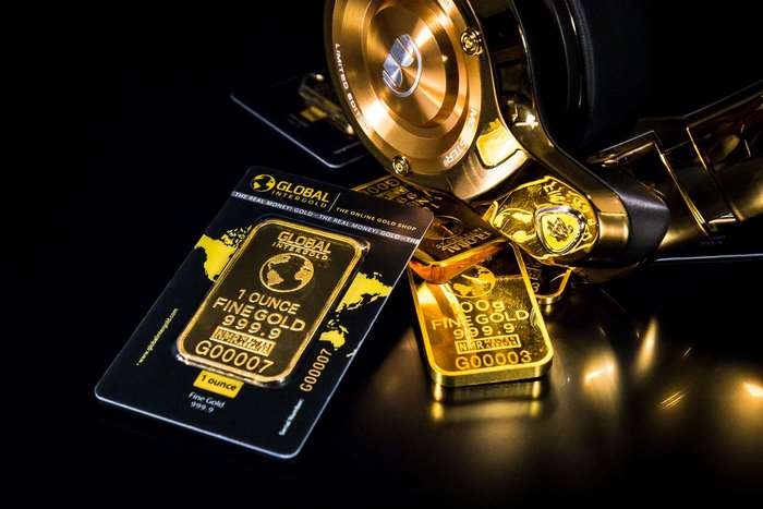 Shiny Gold Bars and Wealth Symbols Close-Up