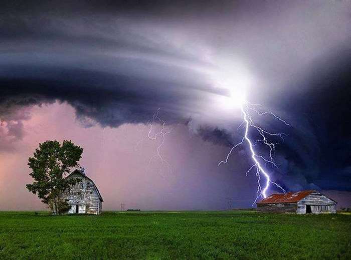 Lightning strikes an old barn on a prairie