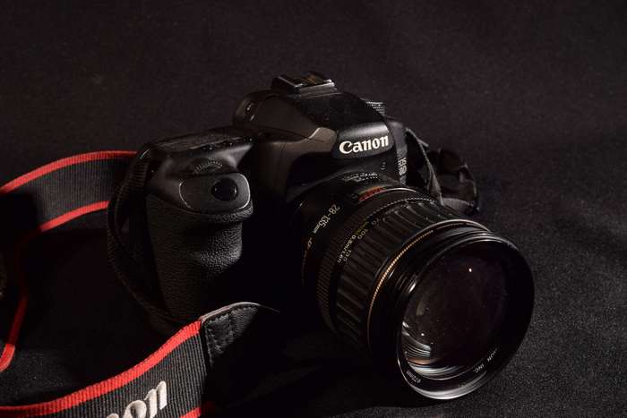 Canon DSLR camera with lens and strap