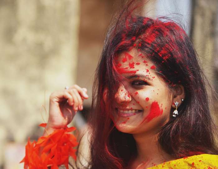 Indian girl with red powder smiling 4K