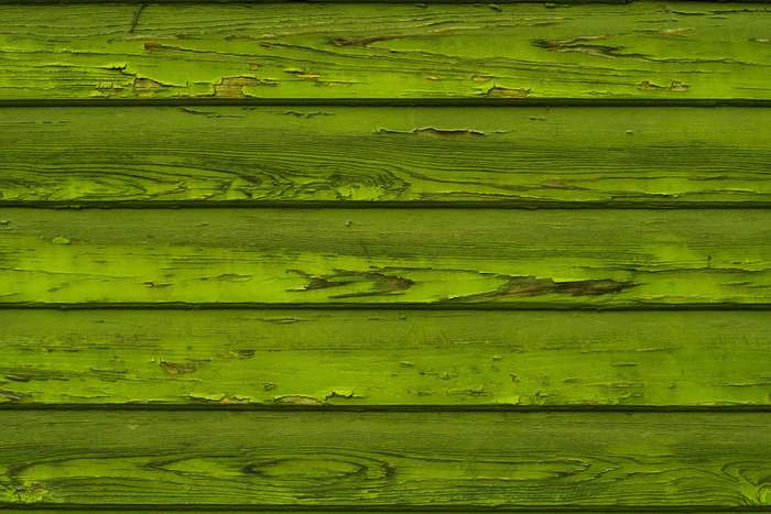 Green painted wood texture with peeling paint