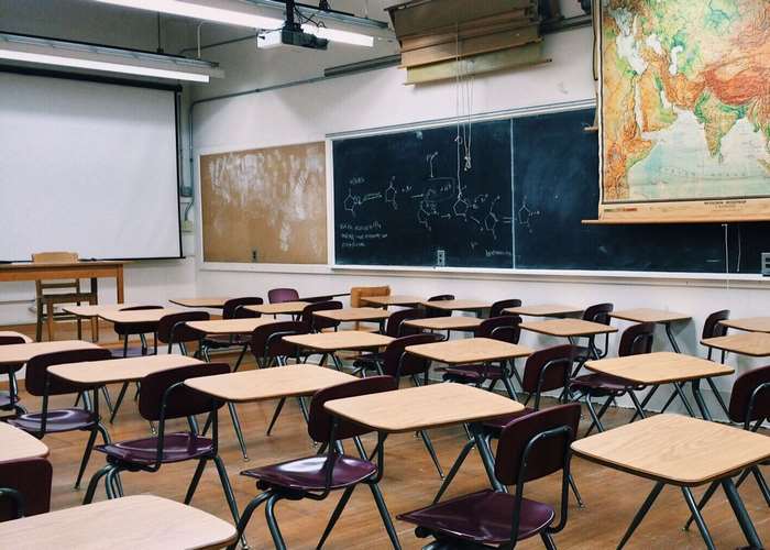 Classroom with desks, chairs, and a world map