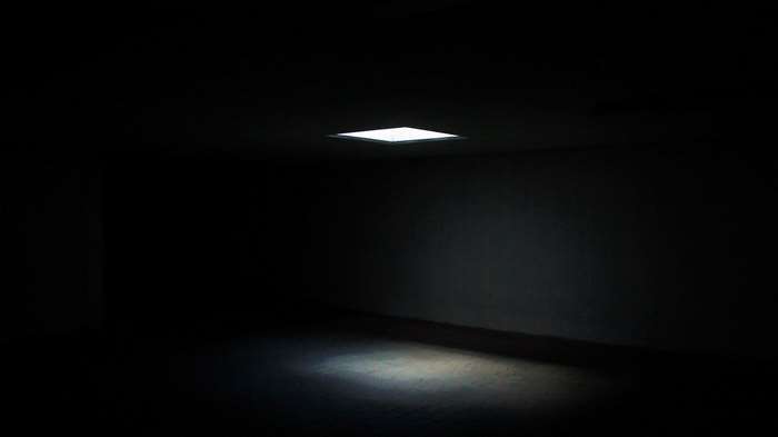 Dark room with a square light on the ceiling