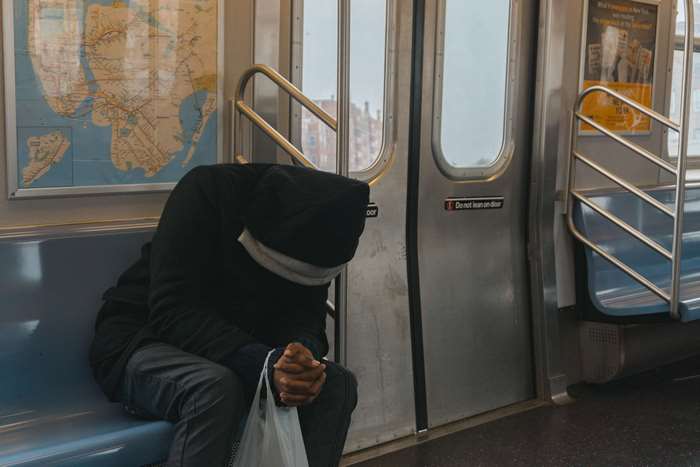 Man sitting on a subway train with a map