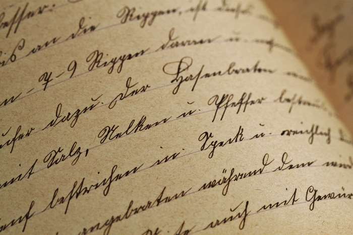 Antique handwritten text on sepia paper 4K