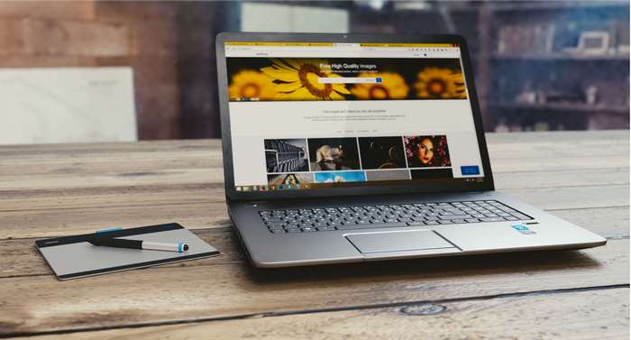 Laptop and graphics tablet on a wooden table