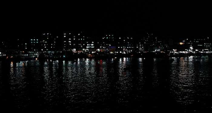 City lights reflecting on water at night