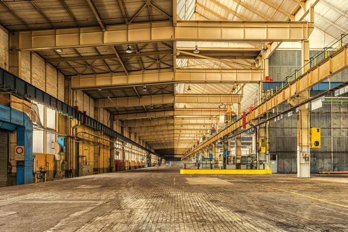 Interior of a large industrial warehouse with metal beams