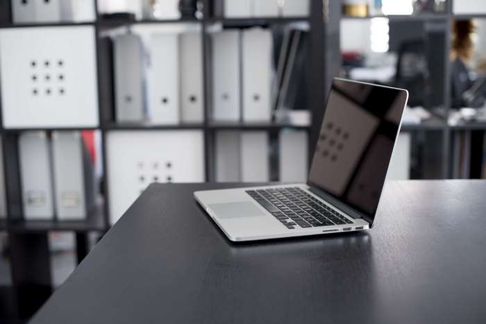 MacBook Pro on a desk in an office