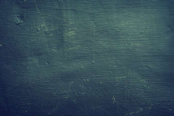 Dark textured surface with faint scratches