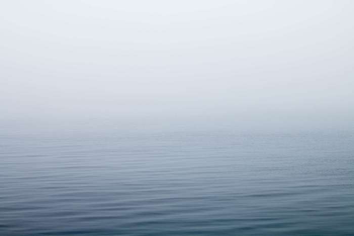 Foggy lake with gentle waves