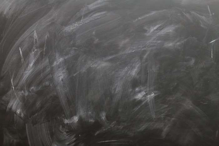 Smeared chalk on a dirty blackboard