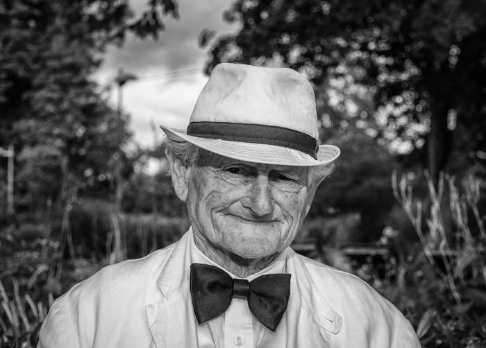 Elderly man in hat and bow tie, portrait 4K