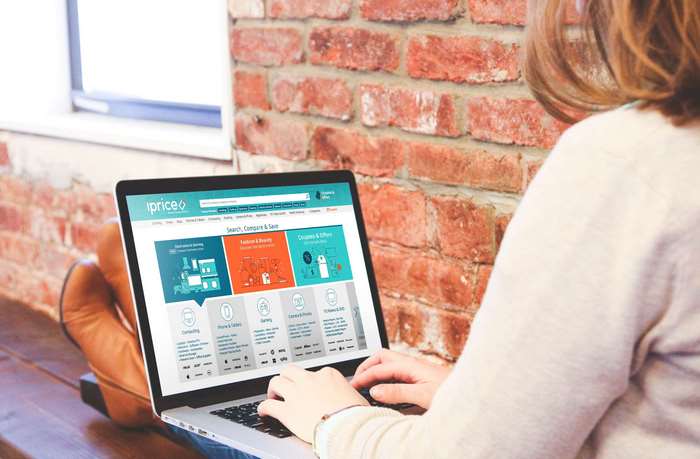 Woman using a laptop with iPrice website