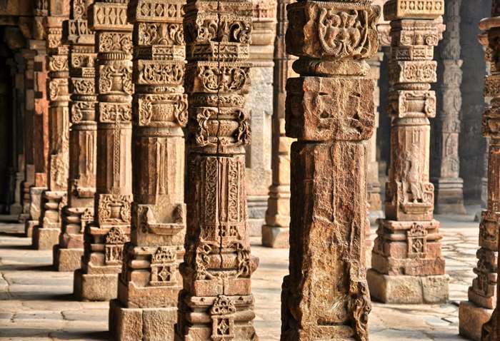 Intricately carved stone pillars in a row