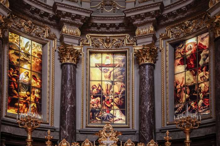 Stained glass windows depicting religious scenes in a church