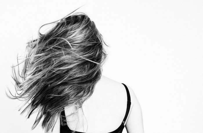 Woman with long windswept hair from behind