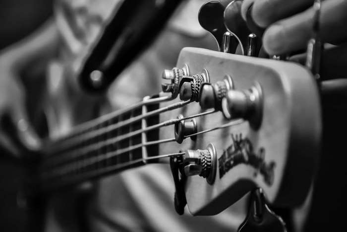 Close-up of a person playing a bass guitar