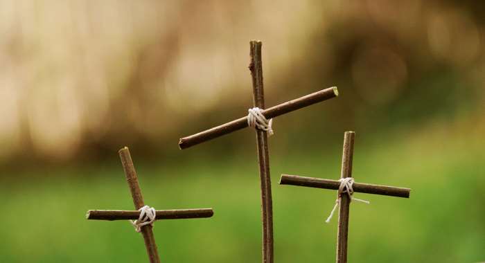 Three crosses made of sticks tied with twine
