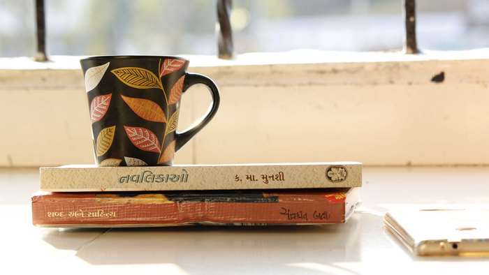 Mug on books with Gujarati text