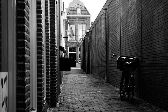 Alley with bicycle and building