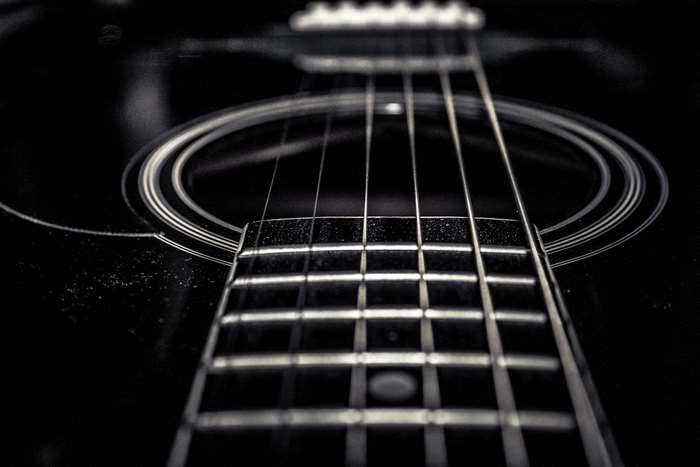 Close-up of an acoustic guitar fretboard and strings