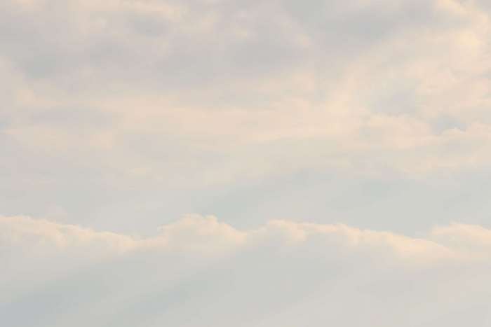 Soft clouds in a pale blue sky 4K